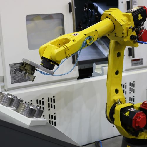 robot arm at a cnc machine